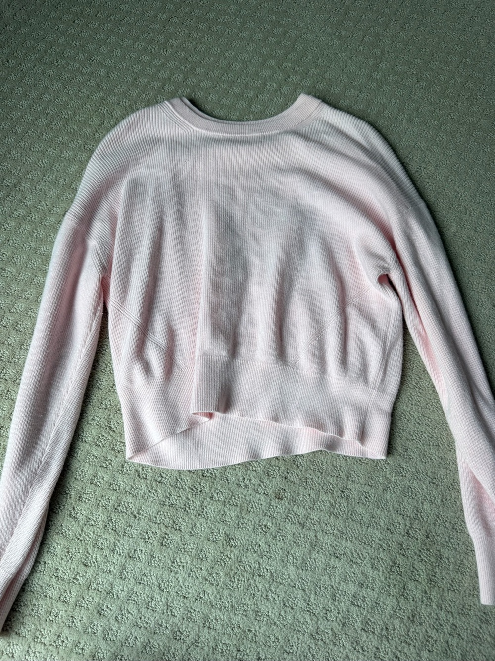 Women’s light pink Lululemon cropped sweater